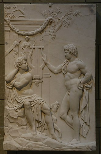 [Attention description longue et avec des blagues]
Amphion et Zèthos, sur un bas-relief de pierre nue qui fait semblant d'être antique mais en fait date de 1850 et qui est dû au sculpteur prussien Julius Troschel.
Sur un fond tout ce qu'il y a plus classique, avec colonnade, petites branches d'arbre, guirlande de fleurs obligatoire, deux mecs fort bien gaulés se font face. L'un est assis sur un bout de rocher, l'intimité recouverte d'un drapé (ce qui permet au sculpteur de flexx). Il tourne la tête en arrière. L'autre est debout, une jambe fléchie, et s'il tient un bout de tissu il le met sur le cucul oubliant de couvrir la partie intéressante. Il tend à son vis-à-vis une énorme lyre qui fait deux fois sa tête.