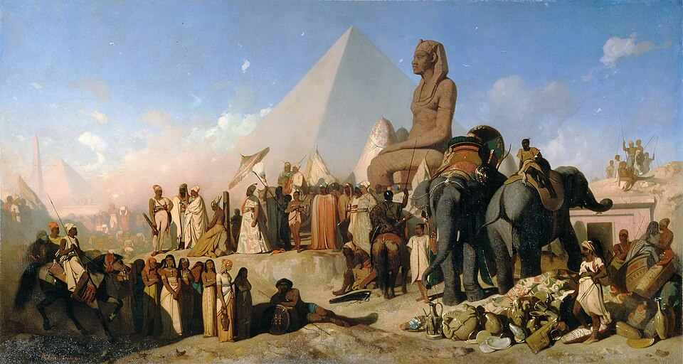 Cambyse et Psammétique, tableau d'Adrien Guignet, vers 1850.

Description longue pour qui veut :
Sur un fond de ciel bleu, et avec une pyramide et une grosse statue égyptienne en arrière-plan, des cortèges se rencontrent. Au premier plan à gauche, un cortège de femmes à la peau noire et brune semble attendre, sous la surveillance de deux gardes à cheval. Au premier plan à droite, un homme armé d'un poignard et quelques serviteurs veillent sur des amas de jarres, amphores et autres vases.
Derrière eux, à gauche, deux gros éléphants sont cornaqués par des hommes noirs. Et enfin, au centre du tableau, quelques personnages importants, suivis par un long cortège, semblent discuter. Le plus notable est un homme en robe longue et coiffé d'une sorte de turban à plumes, debout à l'ombre d'un parasol.
Toutes ces personnes sont en costumes vaguement "orientaux" allant du pagne à la djellaba en passant par le drapé antique.